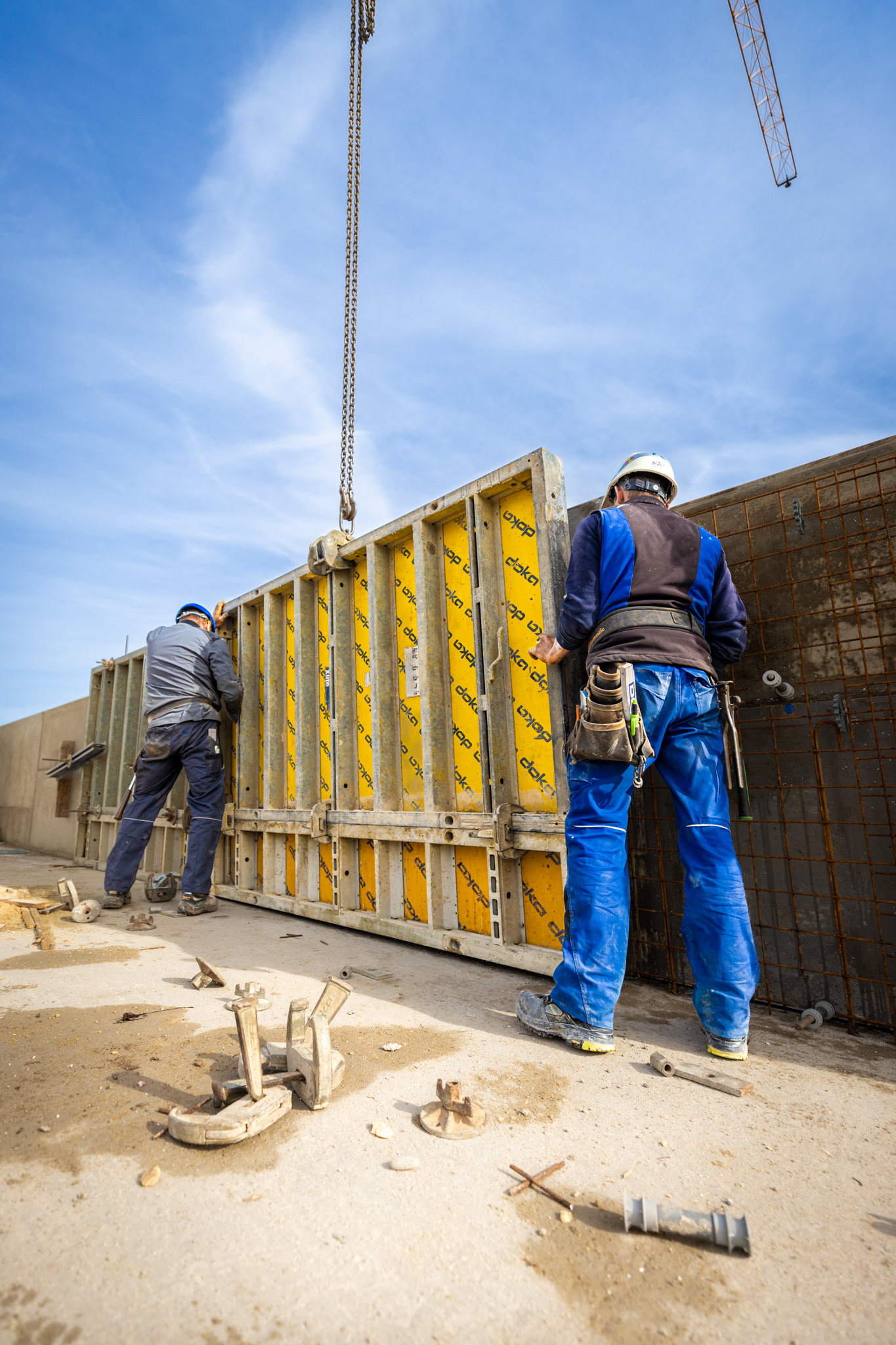 Doll Baustelle zwei Mitarbeiter halten die Schalung Hochformat WEB